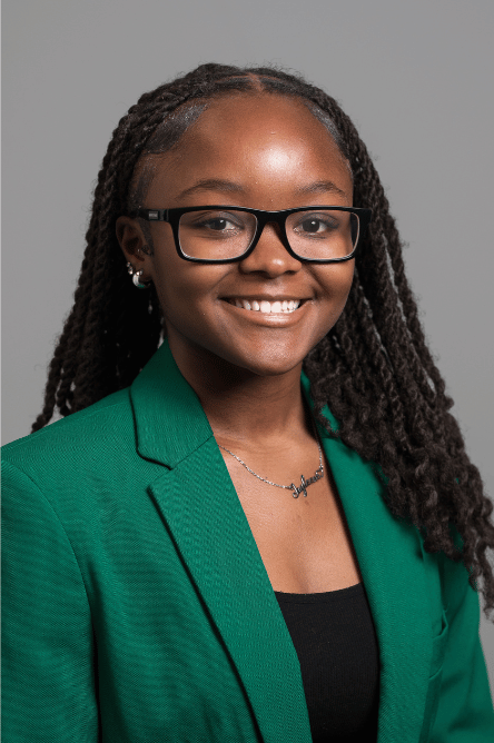 Headshot of a Student ambassador with a green jacket on
