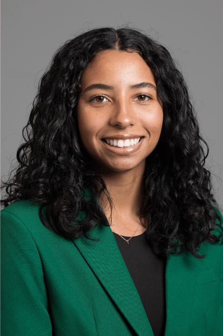 Headshot of a Student ambassador with a green jacket on