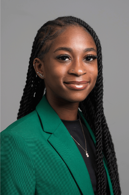 Headshot of a Student ambassador with a green jacket on