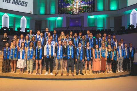 UWF Student Athletes Smiling with Blue Stolls
