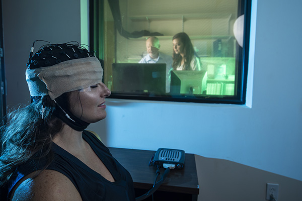 uwf faculty member and student performing a sleep study with a test subject