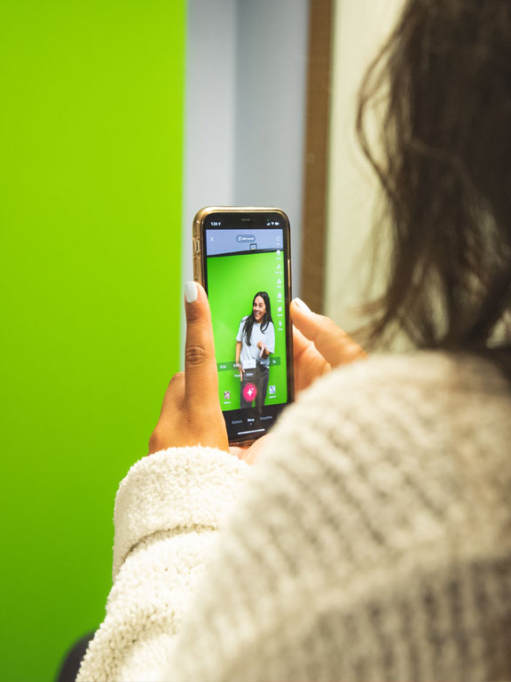 Using a smartphone to video a student against a greenscreen