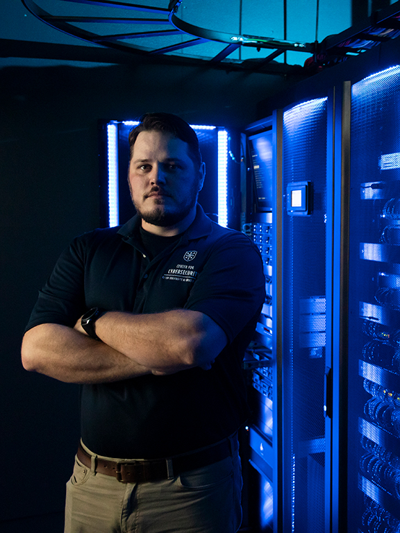 Cybersecurity specialist standing in front of a database
