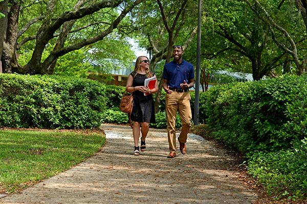two students walking and talking on the pensacola campus