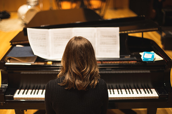 music student playing a piano in the Music Hall at the Center for Fine and Performing Arts