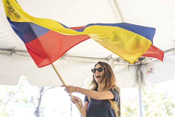 student waving a Venezuelan flag at the annual uwf global block party