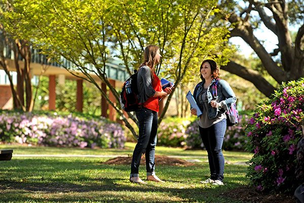 two students conversing outside on the pensacola campus